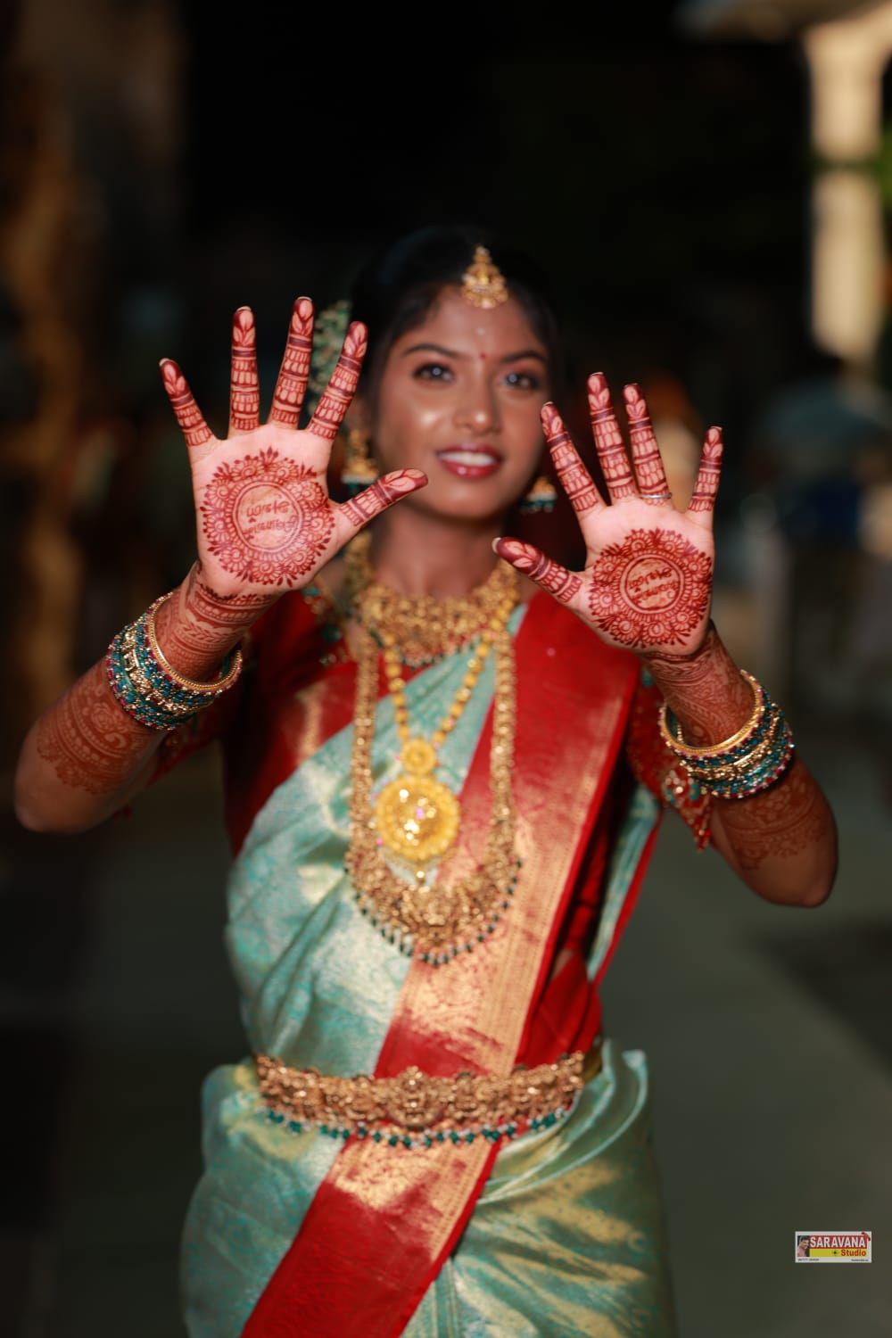 Bride showing full bridal mehandi on both hands