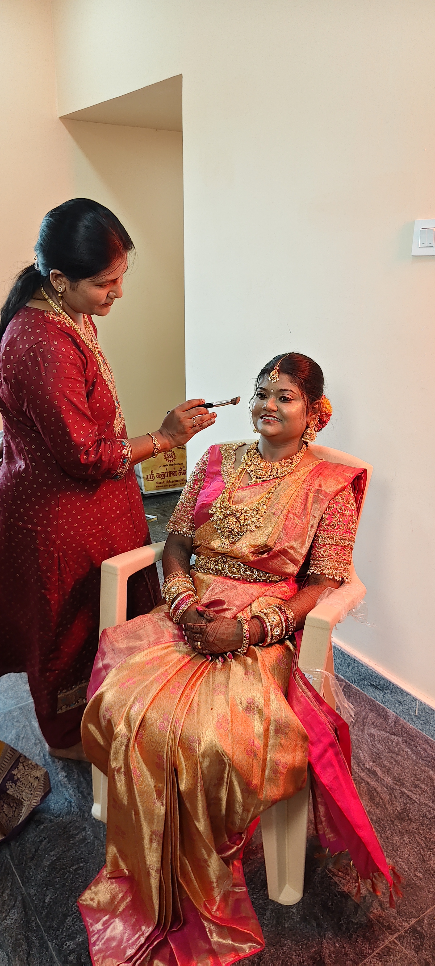 Makeup artist applying bridal makeup on location